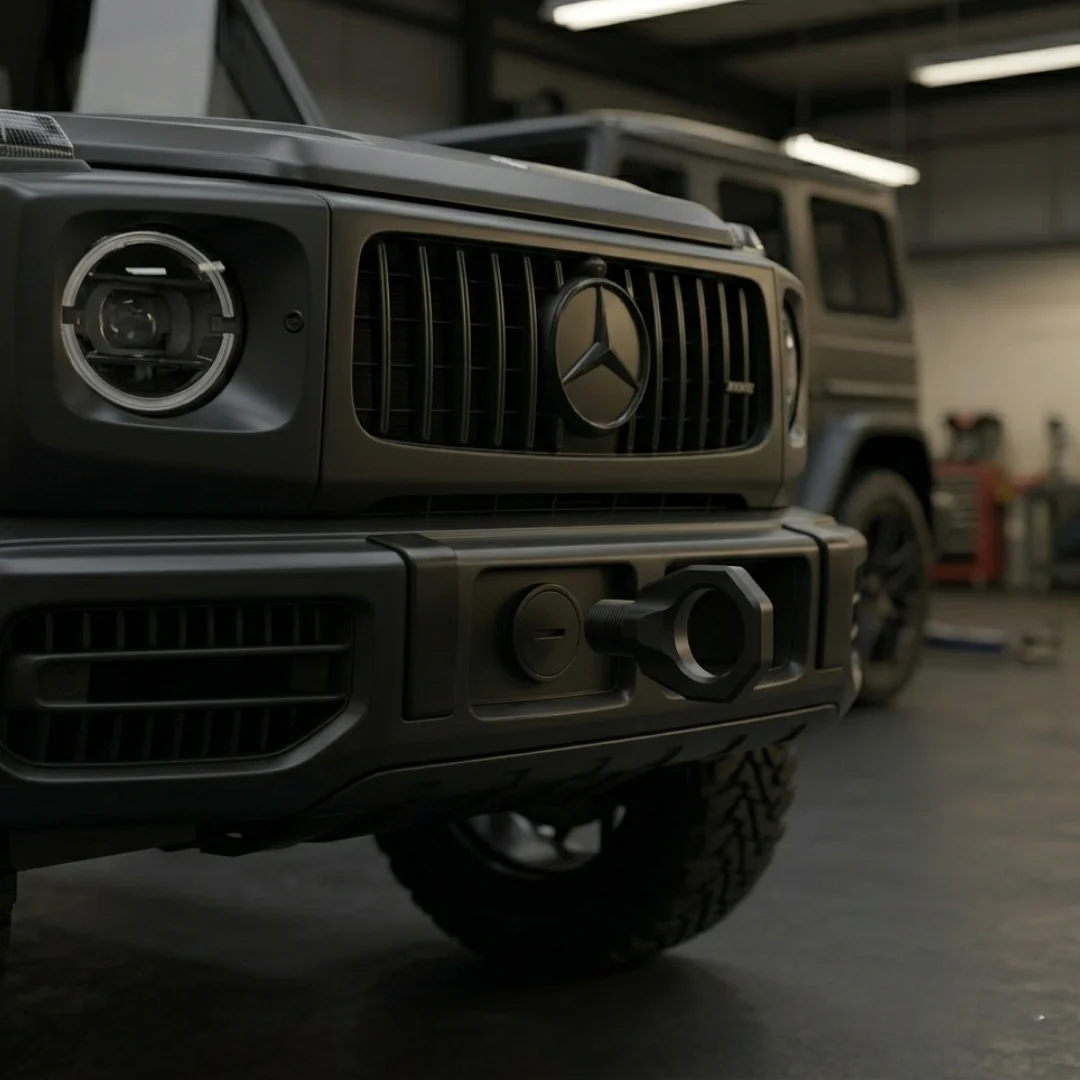 Tow hook matte black DEMIN terpasang rapi di bumper depan mobil sport mewah, menyatu dengan desain bumper secara seamless dari sudut low angle